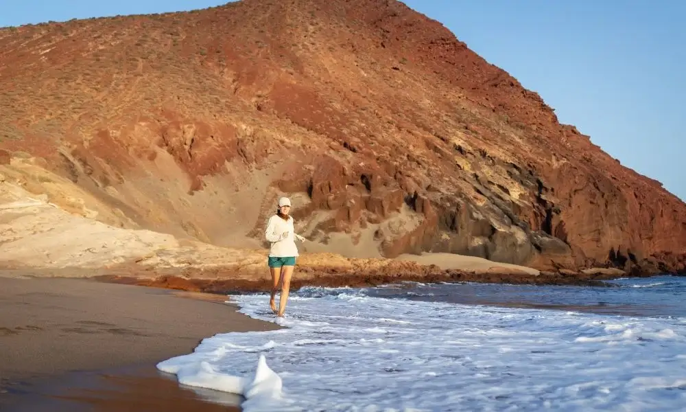 Young women running on La Tejita beach