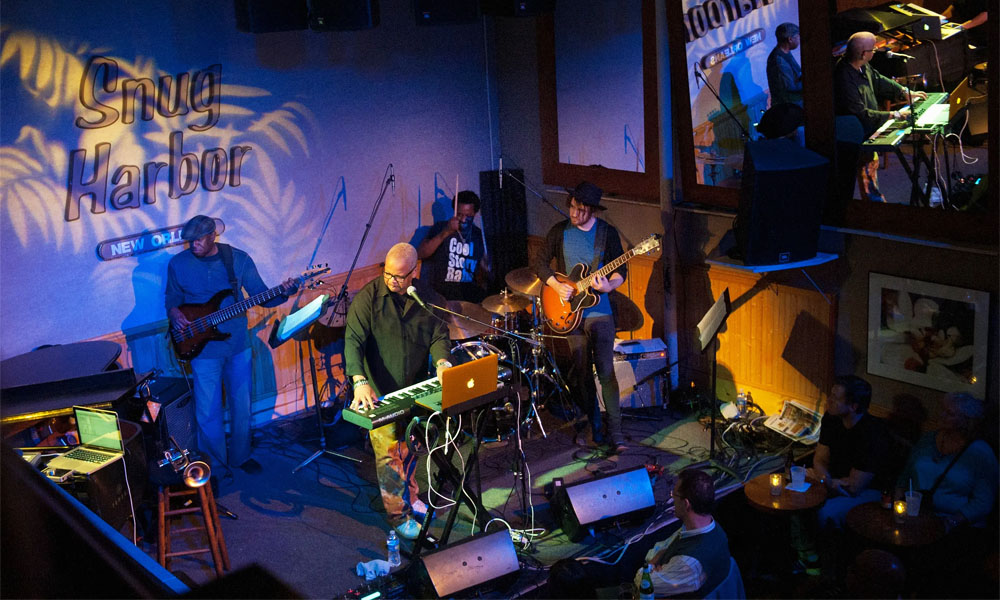 Live performance in the heart of the New Orleans jazz scene with brass band musicians and local crowd